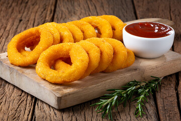Crispy onion rings with ketchup.
