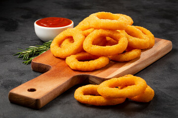 Crispy onion rings with ketchup.