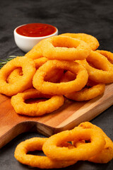 Crispy onion rings with ketchup.