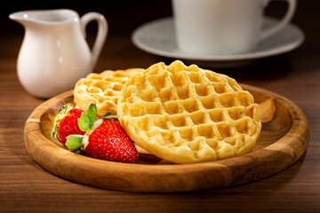 Delicious waffles. Plate with baked waffles on the table.