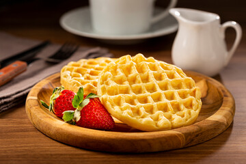 Delicious waffles. Plate with baked waffles on the table.