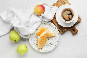 Plate with tasty apple strudel, cup of coffee and fruits on white background