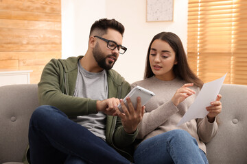 Young couple discussing family budget at home