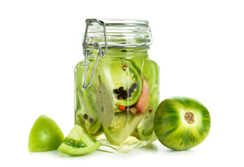 Jar with canned green tomatoes on white background