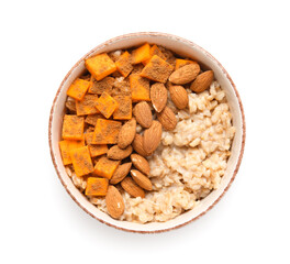 Bowl of tasty oatmeal with pumpkin and almond on white background