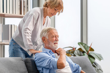 Elderly man with pain in the shoulder. Upper arm pain, Portrait of senior couple in living room, Man neck and shoulder pain and injury
