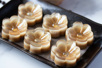 Flower shaped coffee jelly in black plate, Thai dessert