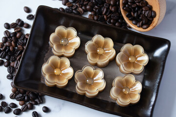 Fototapeta premium Flower shaped coffee jelly in black plate, Thai dessert