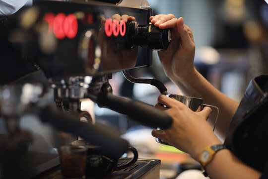 Barista's hands are making coffee with espresso coffee machine. Coffee shop concept