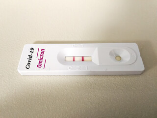 Rapid test cassettes for Covid-19 New Variant Omicron (B.1.1.529) test.  Showing result Positive