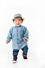 Lovely portrait of cute Asian little boy smiling on smart hat and handsome outfit with happy to play outdoors.