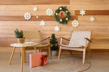 Interior of modern living room with armchairs, table and Christmas decor