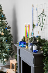 Beautiful decorations for Hanukkah celebration on fireplace in room