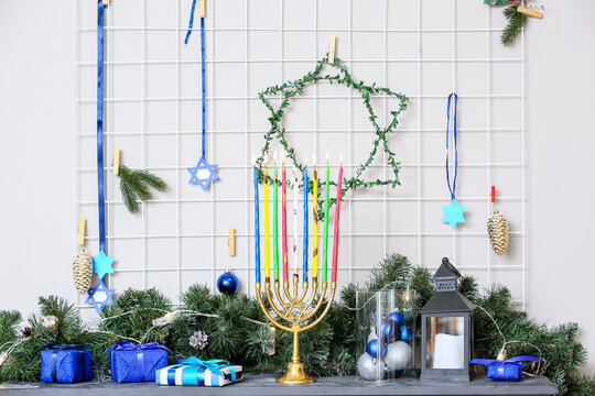 Beautiful decorations for Hanukkah celebration on fireplace in room © Pixel-Shot
