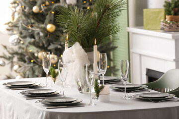 Dining table with beautiful setting for Christmas celebration in festive room