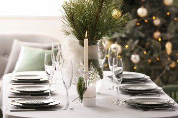 Dining table with beautiful setting for Christmas celebration in festive room