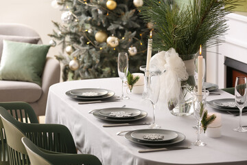 Dining table with beautiful setting for Christmas celebration in festive room