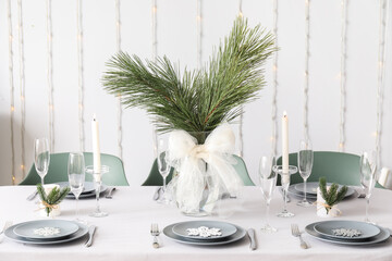 Dining table with beautiful setting for Christmas celebration in festive room