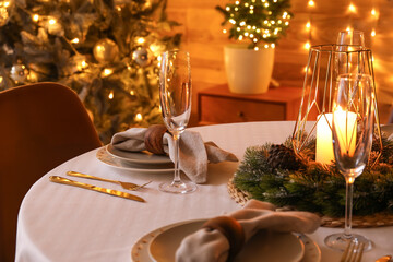 Dining table with beautiful setting for Christmas celebration in festive room