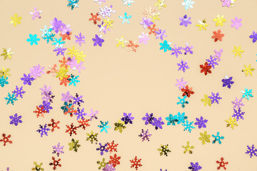 Frame made of beautiful confetti on color background