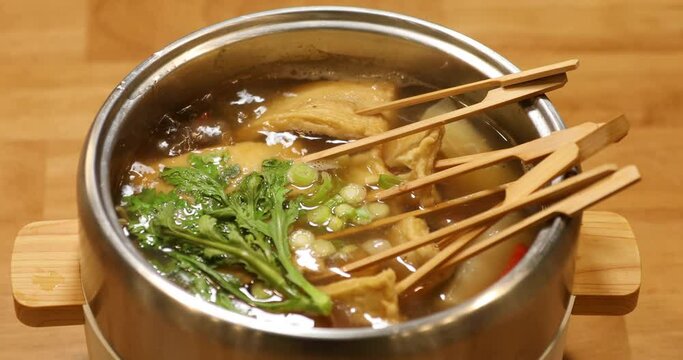 Fish cake soup boiling in an electric pot