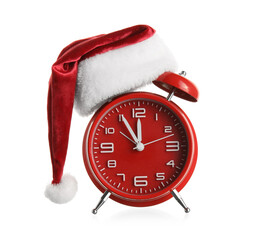Alarm clock in Santa hat on white background
