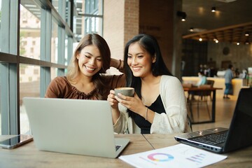 two women with laptop