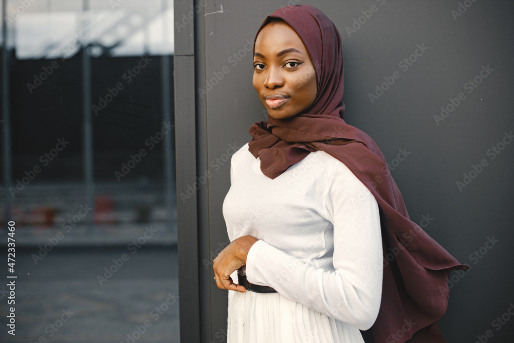 Wall mural portrait of young muslim woman wearing hijab looking at camera