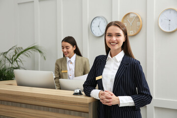 Portrait of beautiful receptionist near counter in hotel