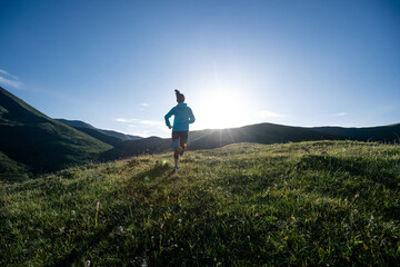 Fitness woman runner running at mountain top