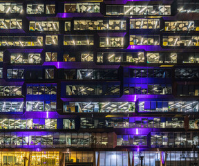 multi-storey office building at night with worker working overtime. late night at office. Late night overtime in a modern office building