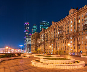 Fototapeta na wymiar Night view Modern Moscow city skyscrapers and old classic Russia architecture. Fantastic view of street, old building and high towers at Moscow summer or spring night.