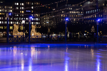 Fototapeta premium Winter in Stockholm. Ice skating in the square in Kungstradgarden. Sweden, Stockholm 