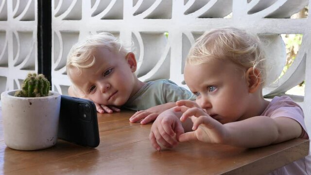 Small kids watching cartoons on the phone