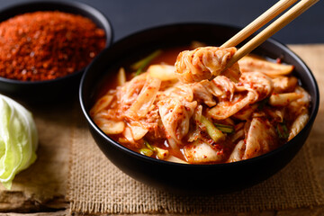 Korean kimchi cabbage in a bowl eating by chopsticks, Asian fermented food, Still Life