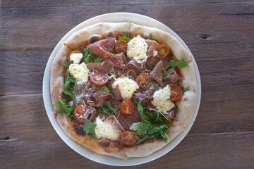 Pizza with Tomatoes, Prosciutto, Arugula and Mozzarella