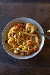 A place of spaghetti with tomatoes and prawns