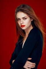 Naklejka premium pretty woman with red lips red hair Glamor posing red background
