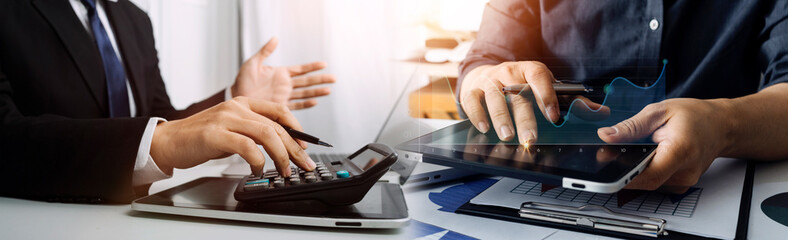 Obraz premium Image of businessmen hands during discussion of data in touchpad at meeting