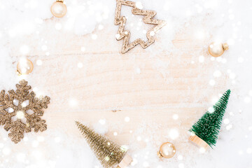 Snow wood background. Christmas board with old rustic wall, white frozen snowflake, golden balls and gift box. Winter wooden decoration background. Merry Christmas holiday card pattern.