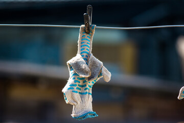 Work gloves to dry on a clothesline, reminiscent of an indecent gesture with a middle finger fuck...