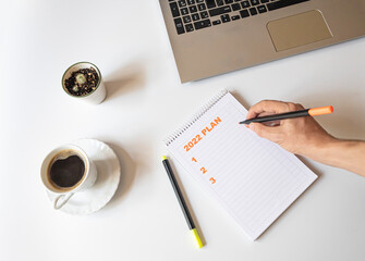 2022 plan notebook list concept.new year plan.
2022 Plan writing in notebook, top view, planning concept,business finance goal setting concept.