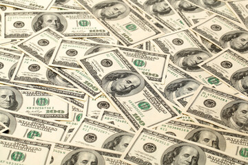 Many bundle of US 100 dollars bank notes isolated on white background