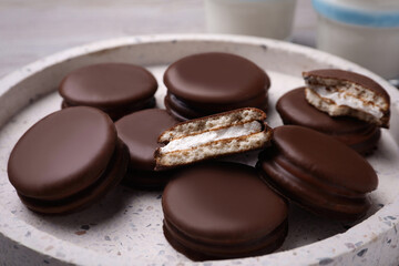 Tasty choco pies in plate, closeup view