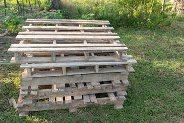 Used of wooden pallets stacked on the lawn.