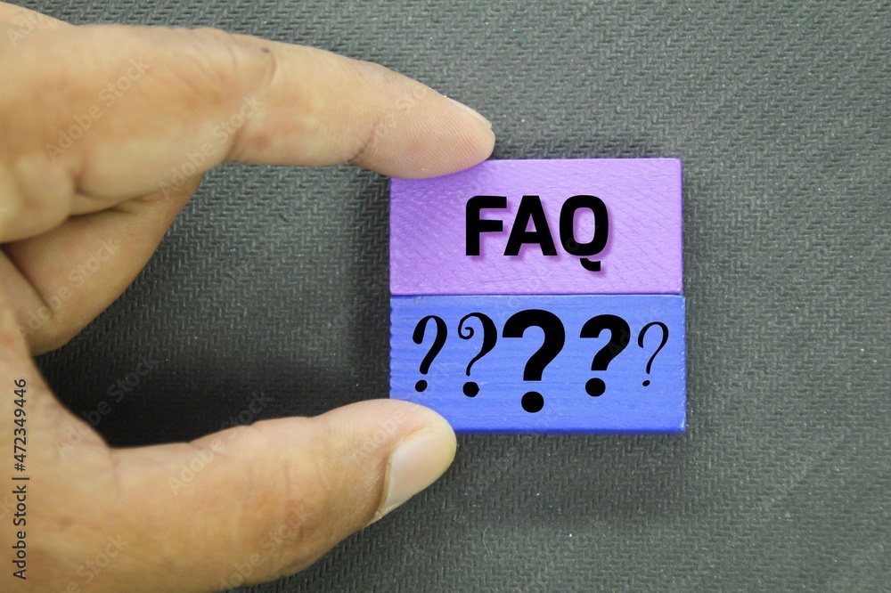 Poster hand holding a colored board with question marks and faq or answers above