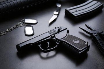 Composition with professional gun on black background