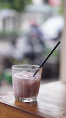 a glass of strawberry jam milkshake