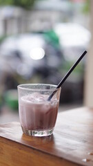 a glass of strawberry jam milkshake