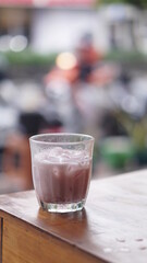 a glass of strawberry jam milkshake
